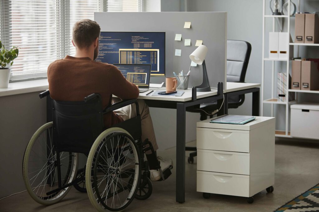 Person in wheel chair working on computer
